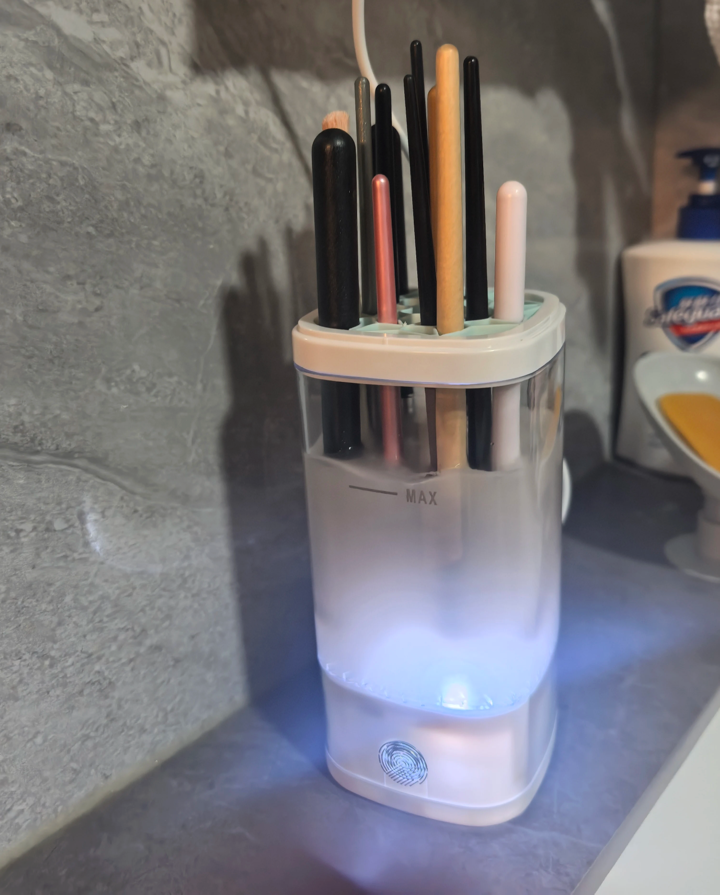 Sample review photo of brushes stored inside the white Nuvie cleaner